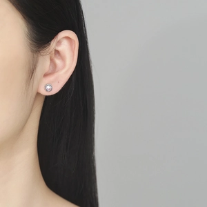 Minimalist S925 sterling silver stud earrings with pink moonstone on a female model