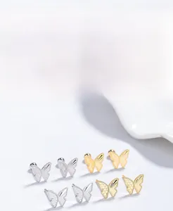 Close-up of S925 sterling silver butterfly stud earrings in silver and gold plated finishes