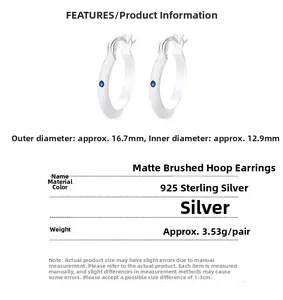 Detailed view of 925 sterling silver hoop earrings with matte finish and blue gemstone