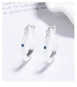 Close-up of S925 sterling silver earrings with blue stone and frosted texture detail