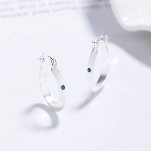 Minimalist 925 silver hoop earrings with brushed matte finish and deep blue zircon stones