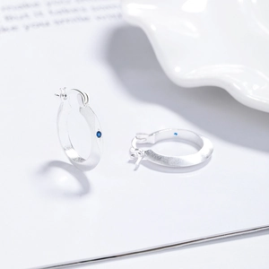 Minimalist 925 sterling silver hoop earrings with brushed finish and blue zircon accent