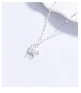 Close-up of 925 silver flower pendant with marquise zircon stones and cross chain