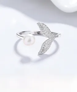 Detail of S925 hallmark on silver mermaid tail ring with pearl and sparkling zircons