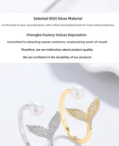 Detail of S925 silver fishtail rings with freshwater pearl and zircons in gold and silver