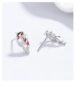 Close-up of 925 silver koi fish earrings with red enamel and sparkling zircon detail