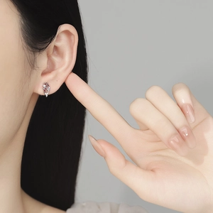 925 silver koi stud earring with red zircon on female model for a classic look
