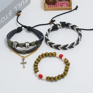 Three-piece set of vintage leather braided bracelets with wooden beads and silver cross