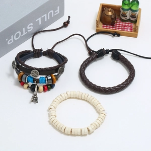 Three-piece set of vintage leather bracelets with peace sign and Eiffel Tower charms