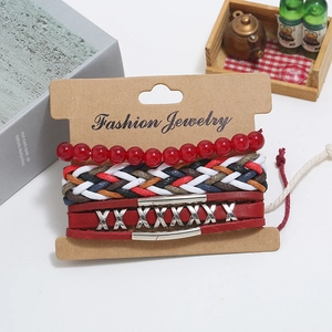 Three-piece vintage bracelet set with red beads, braided rope and leather band on display