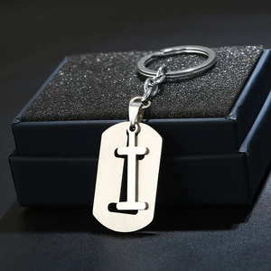 Close-up of letter I engraved on brushed stainless steel keychain in a black gift box