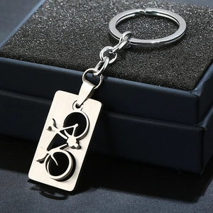 Minimalist stainless steel bicycle keychain with cutout metal plate on a gift box