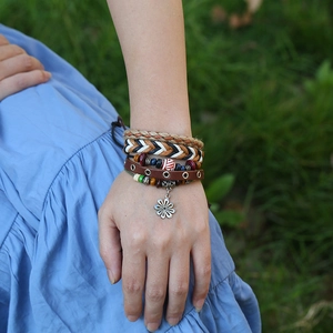 Bohemian multi-layer leather bracelet set with beads and flower charm on model