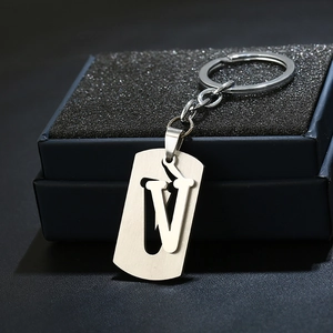 Detail showing letter V stainless steel keychain with brushed metal plate and gift box