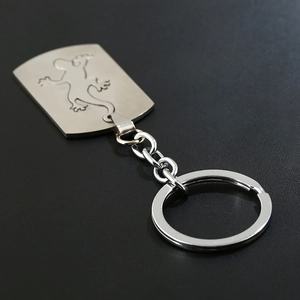 Brushed stainless steel keychain with gecko lizard engraving on flat metal pendant