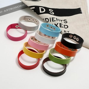 Detail of adjustable leather bracelets with silver metal snaps in multiple vibrant colors