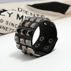 Punk black leather wide bracelet featuring three rows of gunmetal pyramid studs for rock style