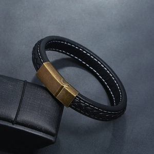 Close-up of black leather bracelet with white stitching and antique bronze magnetic clasp