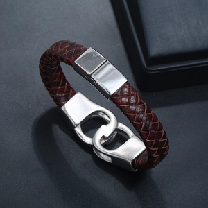 Detailed macro view of dark brown braided leather and polished silver metal clasp