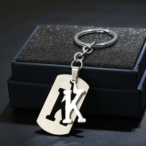 Detailed view of stainless steel keychain featuring a hollow K-letter charm and brushed finish