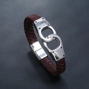 Detailed close-up of brown braided leather strap and interlocking silver steel handcuffs