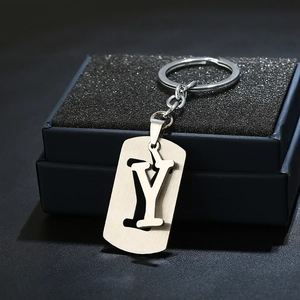 Macro view of minimalist stainless steel keychain with hollow letter Y on black gift box