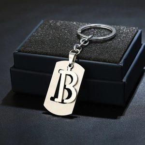 Detail of silver brushed metal letter B keychain with polished ring and sturdy link
