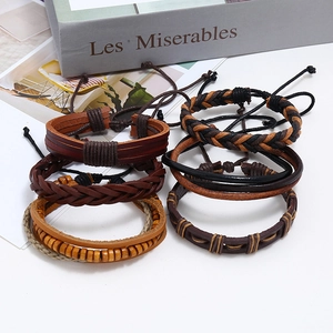 Detail of six-piece vintage leather bracelet set layered with wood beads and woven straps