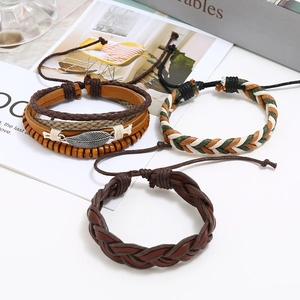 Three-piece vintage braided leather bracelet set with feather charm and wood beads