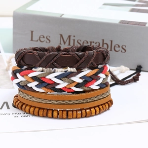 Detail of vintage braided leather bracelet set with colorful cords and wooden beads