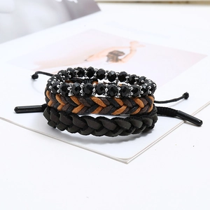 Detail of bohemian 3-piece bracelet set with black beads and hand-woven wax cords