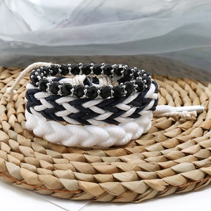 Close-up of a 3-piece punk DIY bracelet set featuring woven cords and beaded textures