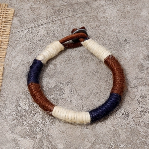 Bohemian braided leather and rope bracelet in navy, tan, and cream with a metal clasp