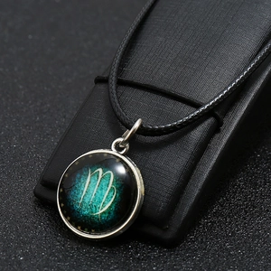 Detail of Virgo constellation necklace with glowing green nebula pendant and cord
