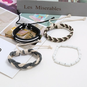 Detail of four-piece handmade leather bracelet set with woven ropes and wooden beads