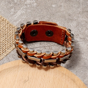 Retro multi-layer brown braided leather bracelet with vintage metal charms and dual snap buttons