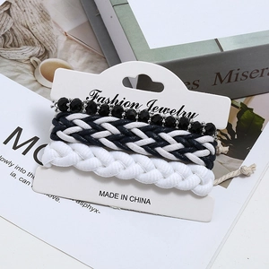 3-piece black and white woven bracelet set with faceted beads on fashion display card