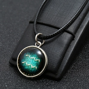 Macro shot of Aquarius constellation necklace with star sky pendant on display