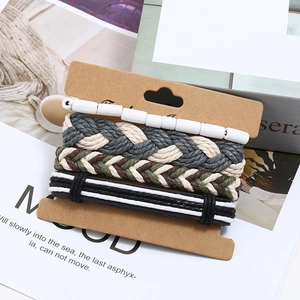 Four-piece punk woven bracelet set with wooden beads and leather cords on brown card
