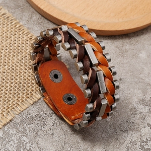 Macro detail of multi-layer woven leather bracelet with vintage metal buckles and texture
