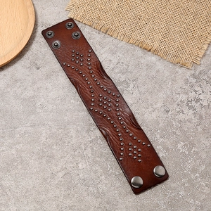 Vintage brown leather punk bracelet featuring silver metal studs and snap button closures