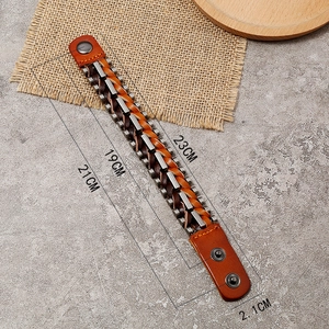 Detail view of vintage woven leather bracelet with metal links and dual snap closure
