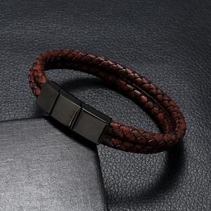 Close-up of dual-layer braided leather men's bracelet with black matte metal magnetic clasp