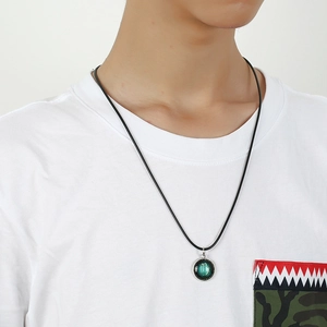 Luminous Virgo constellation pendant necklace with green galaxy background on a black cord