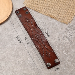Detailed view of punk leather bracelet showing size 22cm and metal stud patterns