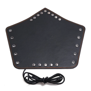 Punk black leather wrist guard with silver studs and braided cord on white background