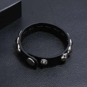 Men's punk black leather bracelet featuring silver cone studs and metal snap closure