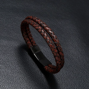 Close-up of double-layer woven brown leather bracelet with black magnetic metal clasp