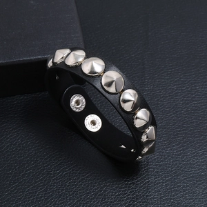 Men's punk leather bracelet featuring silver cone studs and adjustable metal snap buttons