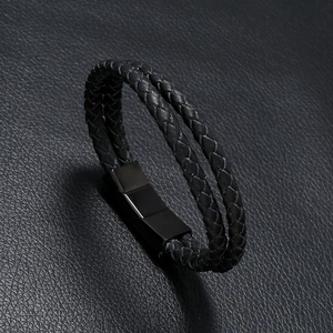 Detail of double-layer black braided leather bracelet with brushed metal magnetic clasp